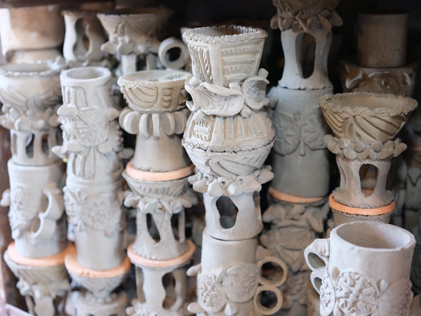 A collection of handmade clay pottery with intricate designs showcasing artistic craftsmanship.